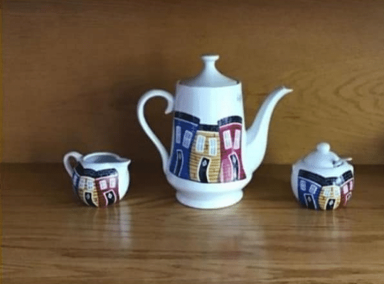 Tea pot and cream and sugar featuring colourful row houses of St. John's by NERRL Hand Painted Designs