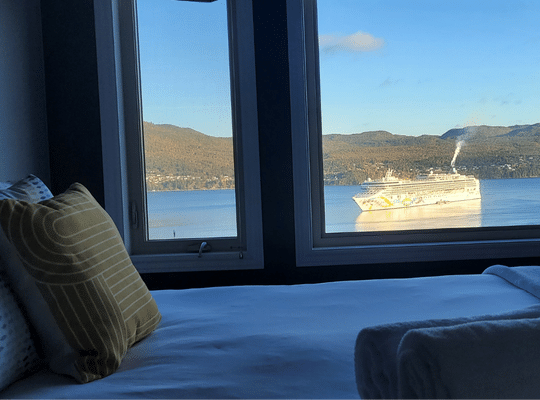 Coastal Lookout Suites bedroom view of ship in bay