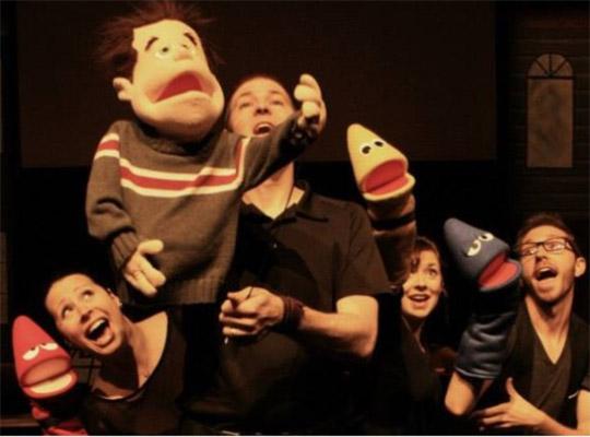 a group pf performers on stage with puppets