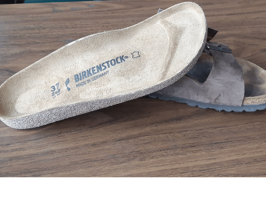 A pair of Birkenstock soles lie on a counter ready to repair a pair of Birkenstocks at the Modern Shoe Hospital Duckworth Street