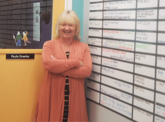Image of Paula Greeley of Clean Start in front of her office door