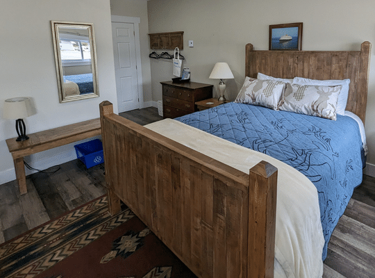 Comfortable Bed with Blue Bedspread at Trailway Hub