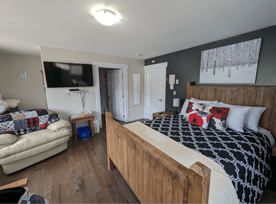 Comfortable Bed with Black and white Bedspread at Trailway Hub