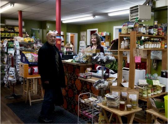 a woman serving a man in a general store