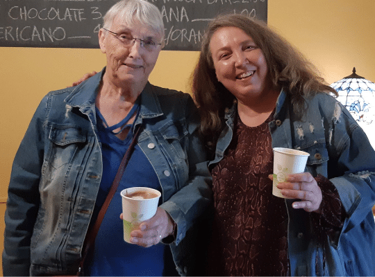 Women smiling with coffee.  Elaine Janes and her mom at Elaine's Cafe