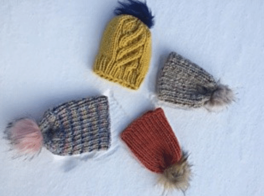 Four hats in the snow