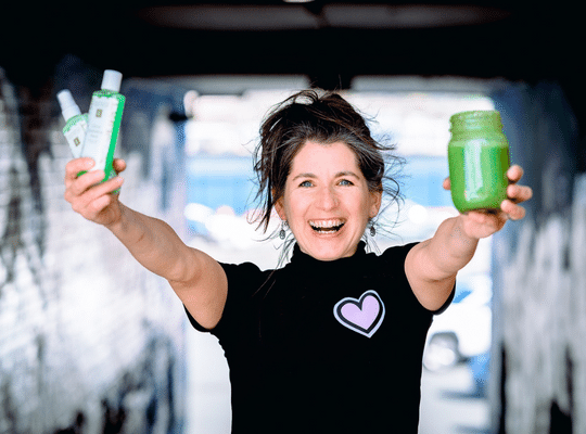 Smiling Gloria Williams holding smoothie