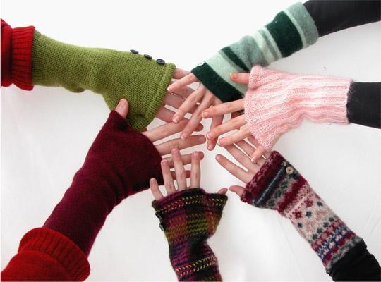 Hands wearing cute knitted creations