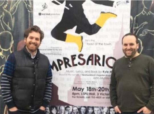 Kyle Mcdavid and Timothy Matson standing in front of a poster for their production of impresario
