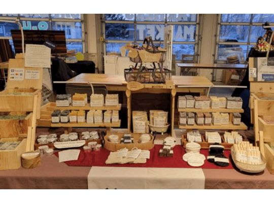 Market Display of Mudders Soap Products - Soaps, shower steamers, solid shampoo bars, shaving pucks, facial bars, milk bath soaks, soap holders, and more!