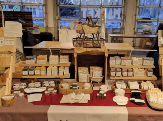 Market Display of Mudders Soap Products - Soaps, shower steamers, solid shampoo bars, shaving pucks, facial bars, milk bath soaks, soap holders, and more!