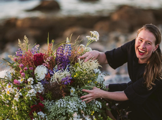 Newfoundland Floral Design Kristyna with a bouquet on the beach