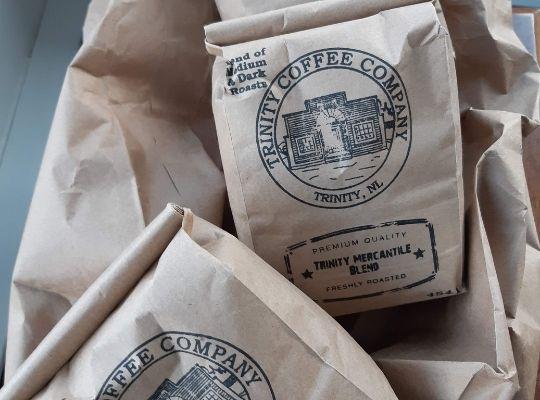 stacked bags of premium quality roast from Trinity Coffee Company