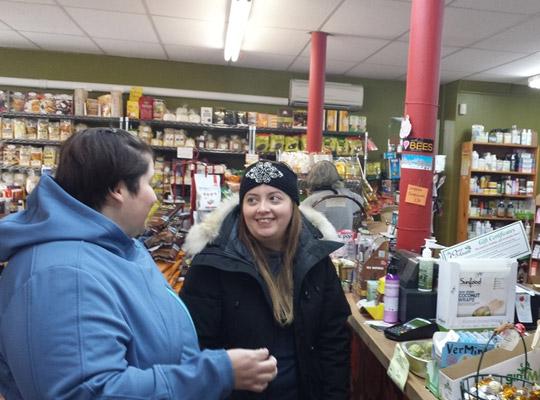 two happy customers chatting by the counter at Food for Thought healthy grocery