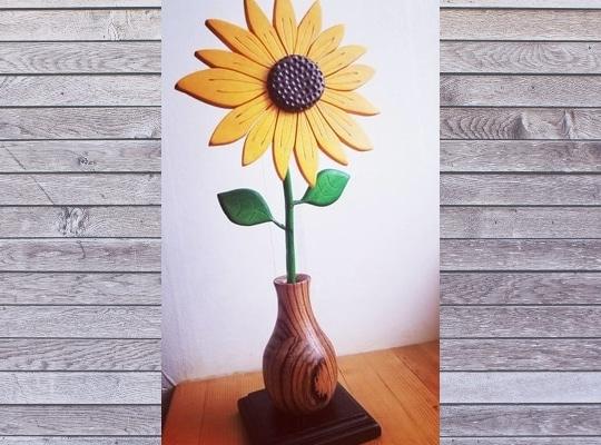 bright yellow sunflower made of wood in a wooden turned vase