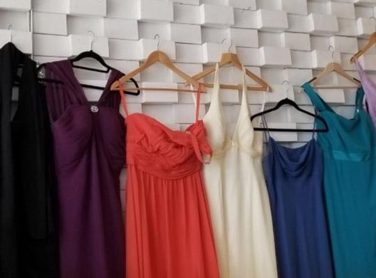 colourful prom dresses lined up on hangers