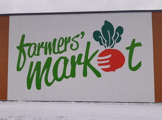big st. john's farmers market logo on side of the building