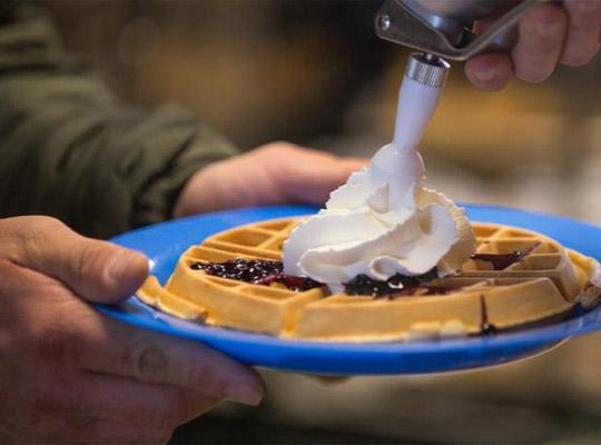 whipping cream on a waffle